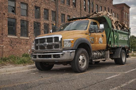 Commercial recycling pickup truck at a business